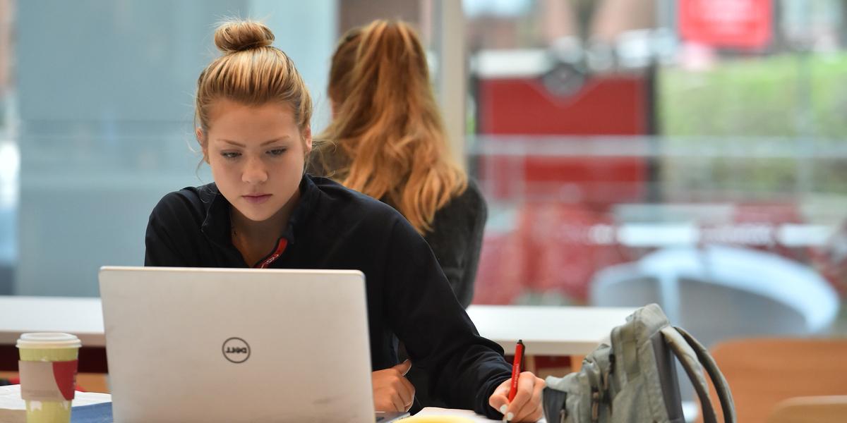 student using laptop in study area