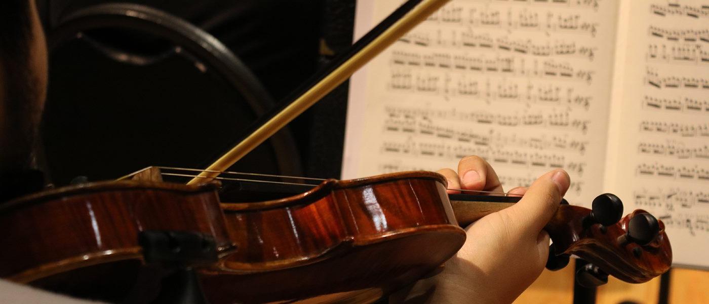 violin player looking at sheet music