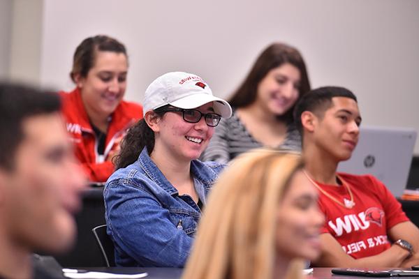 Student in classroom smiling