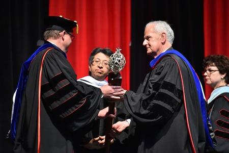 Dr. Evans accepts the Inaugural Symbols