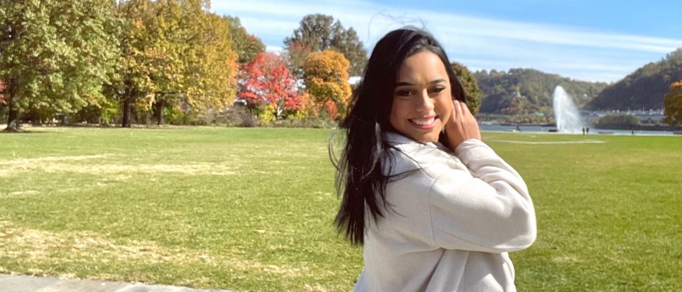 Brittnay Hernandez in front of a field