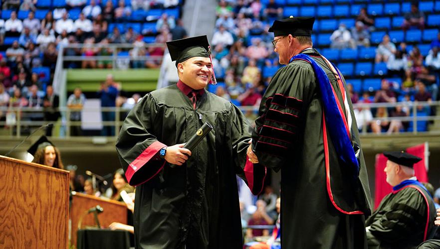 Graduate shaking Dr. Evans's hand